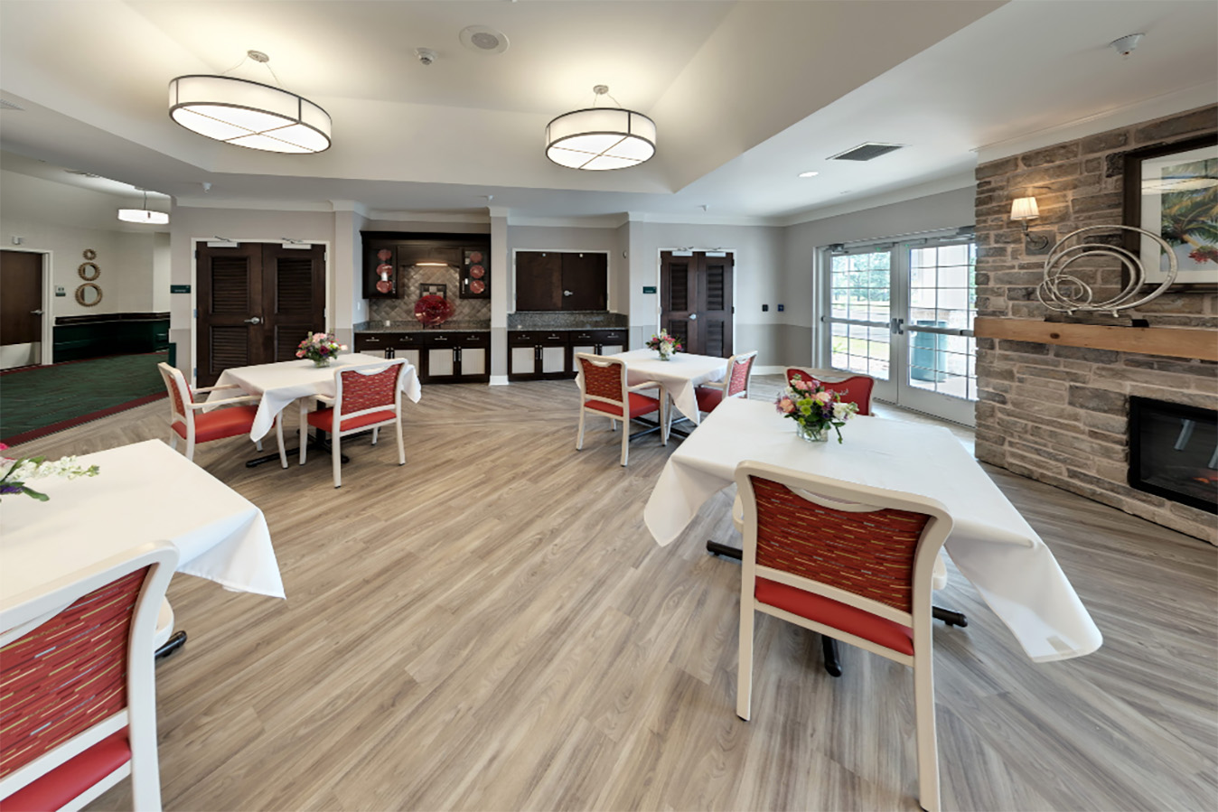 Bright dining room with tables and flowers