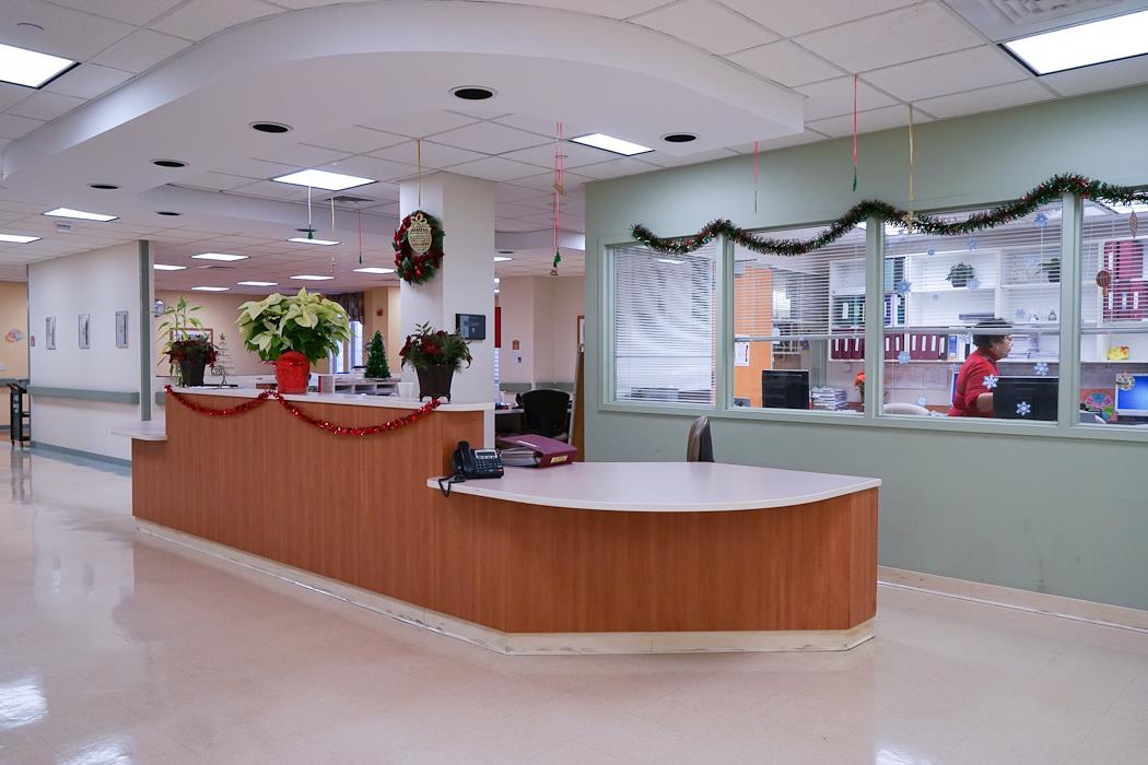 Interior view of a decorated reception area with staff member