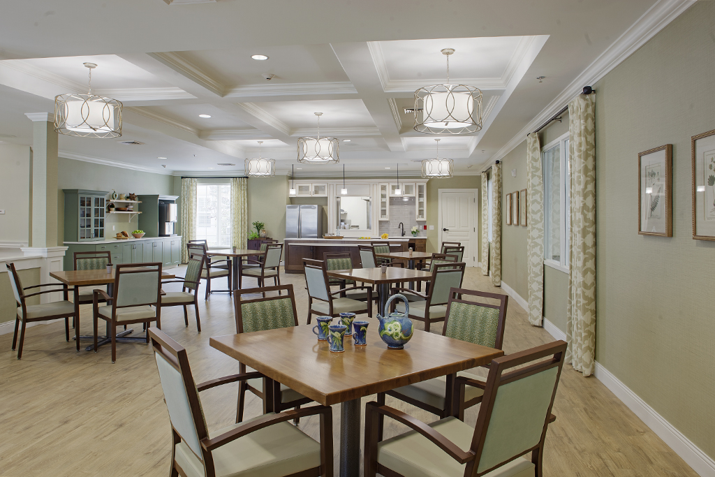 Bright dining room with tables and chairs for residents