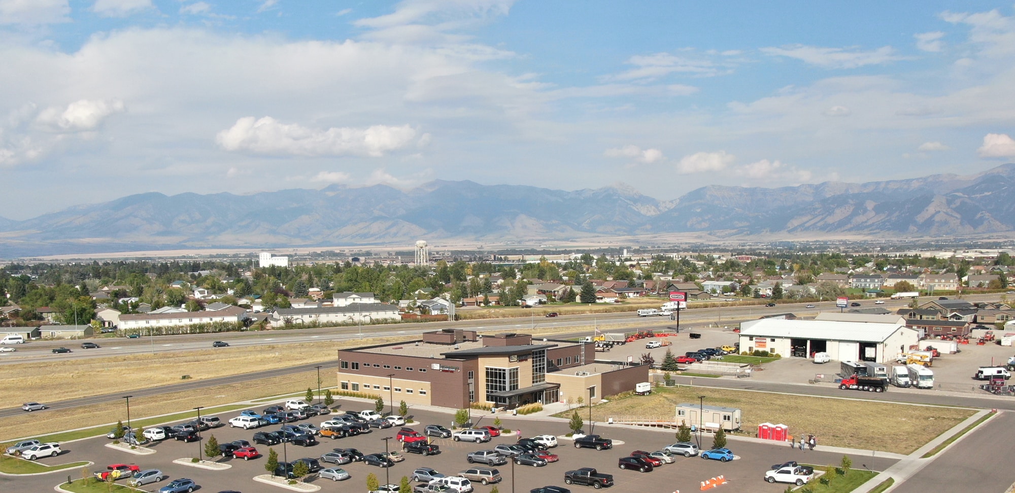 Aerial view of assisted living facility with surrounding landscape