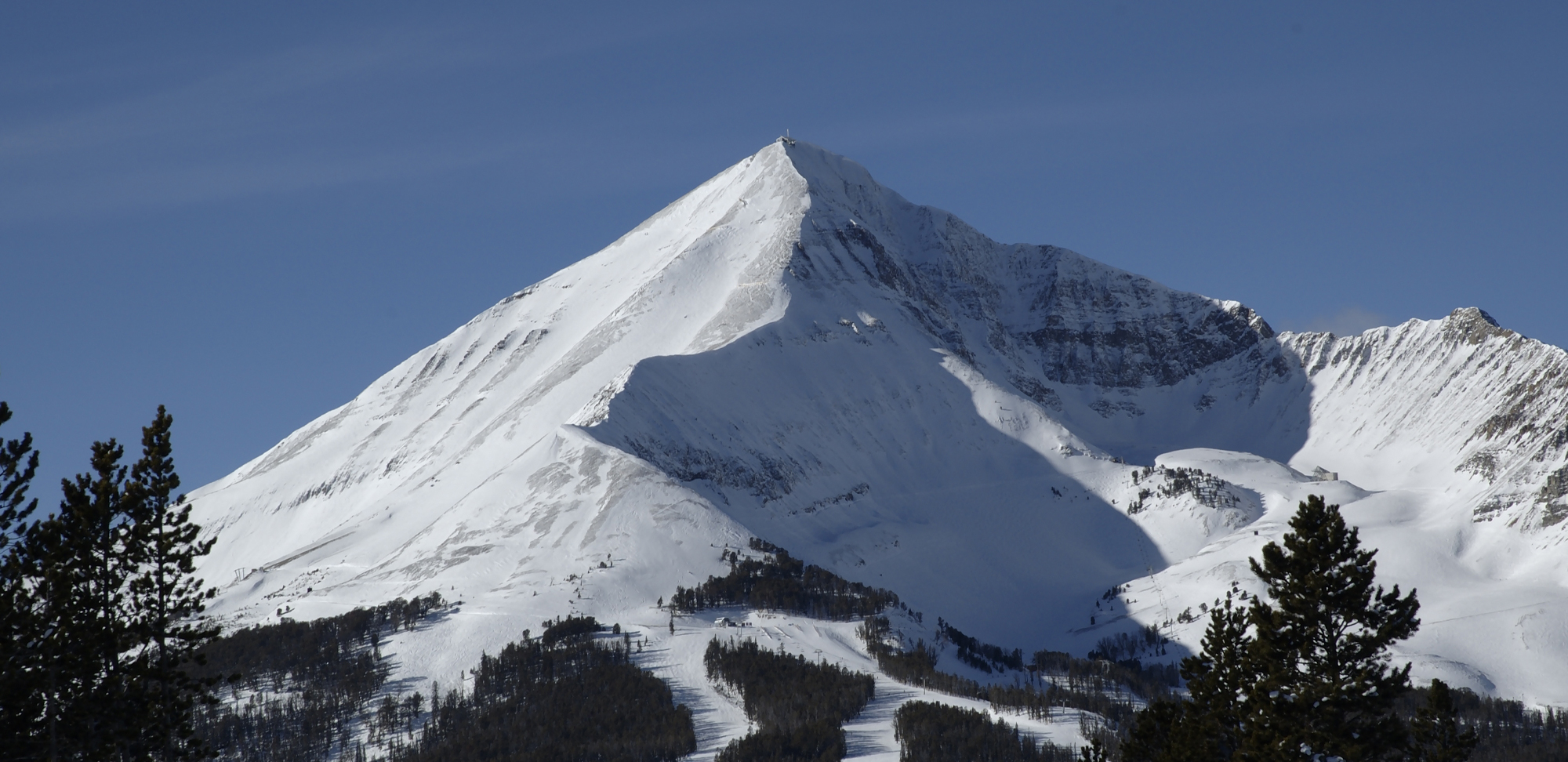 Snow-capped mountain under a clear blue sky