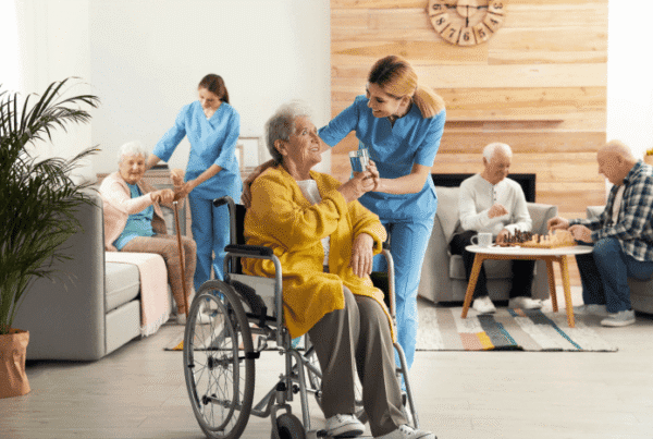 Residents interacting with staff in a cozy lounge area