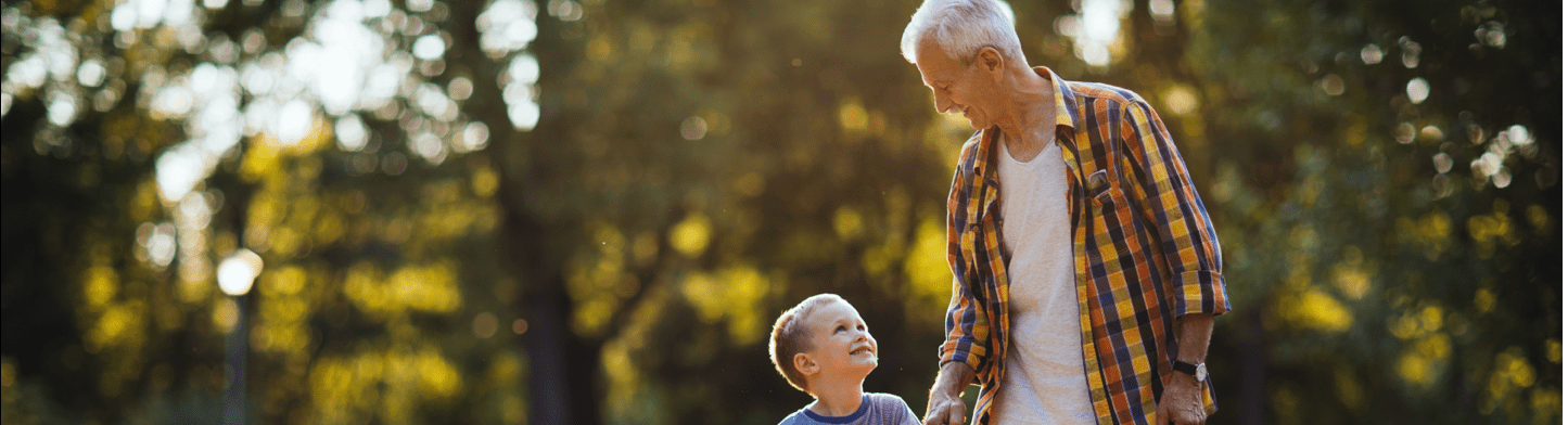 Grandparent and grandchild enjoying a walk in the park
