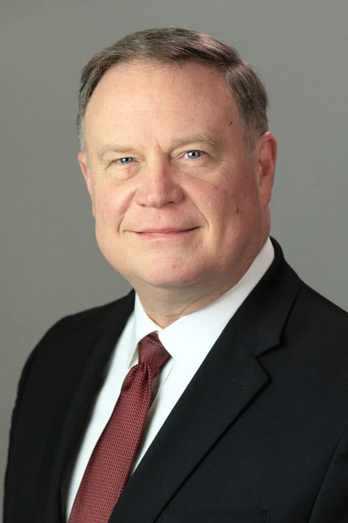 Professional headshot of a man in a suit