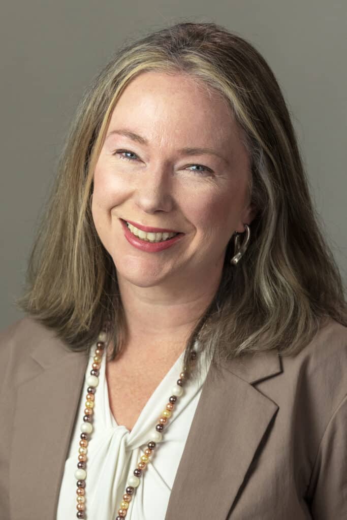 A smiling woman in professional attire