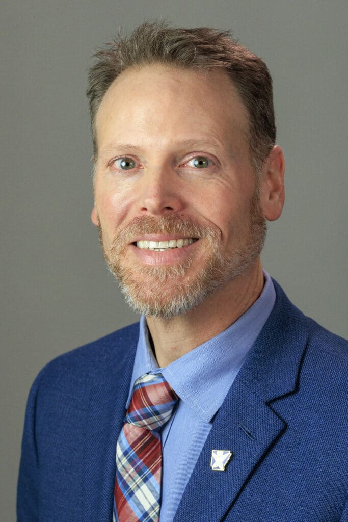 Professional headshot of a staff member in business attire