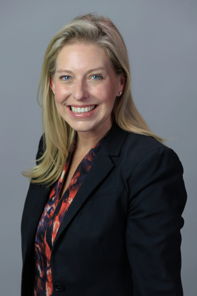 A woman smiling in a business suit