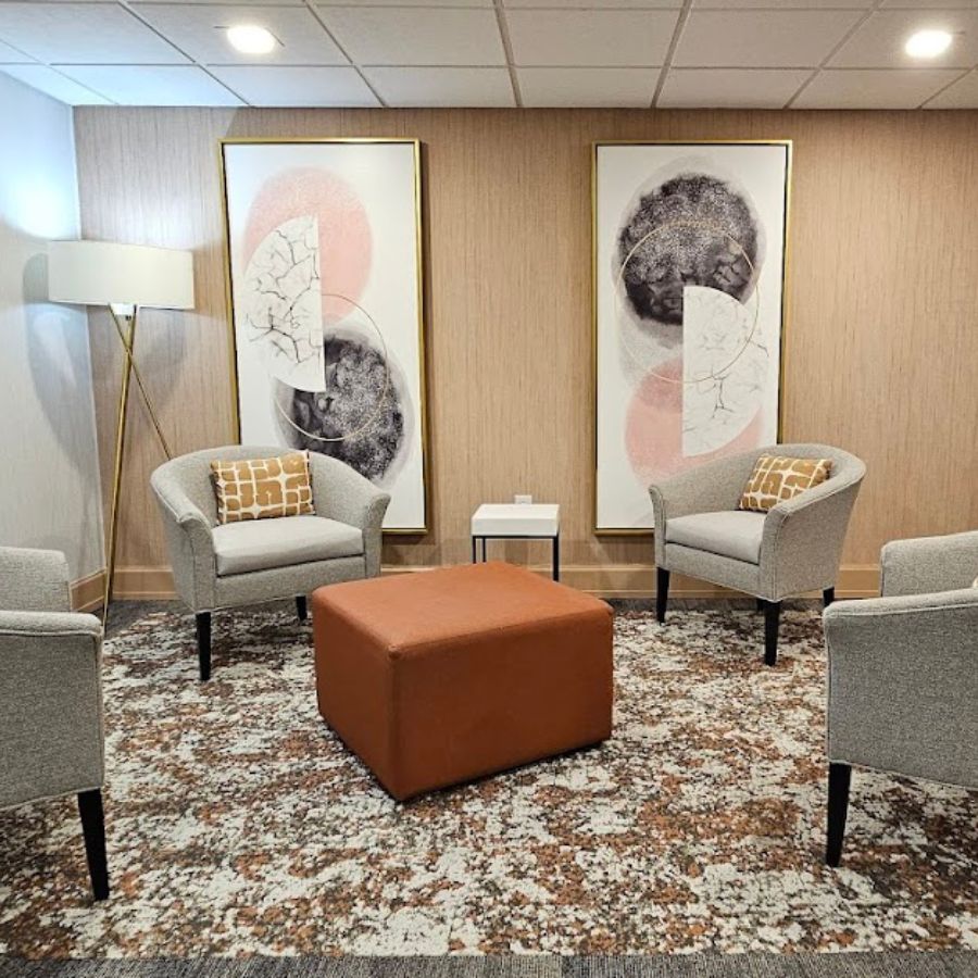 Cozy interior lounge area with chairs and artwork