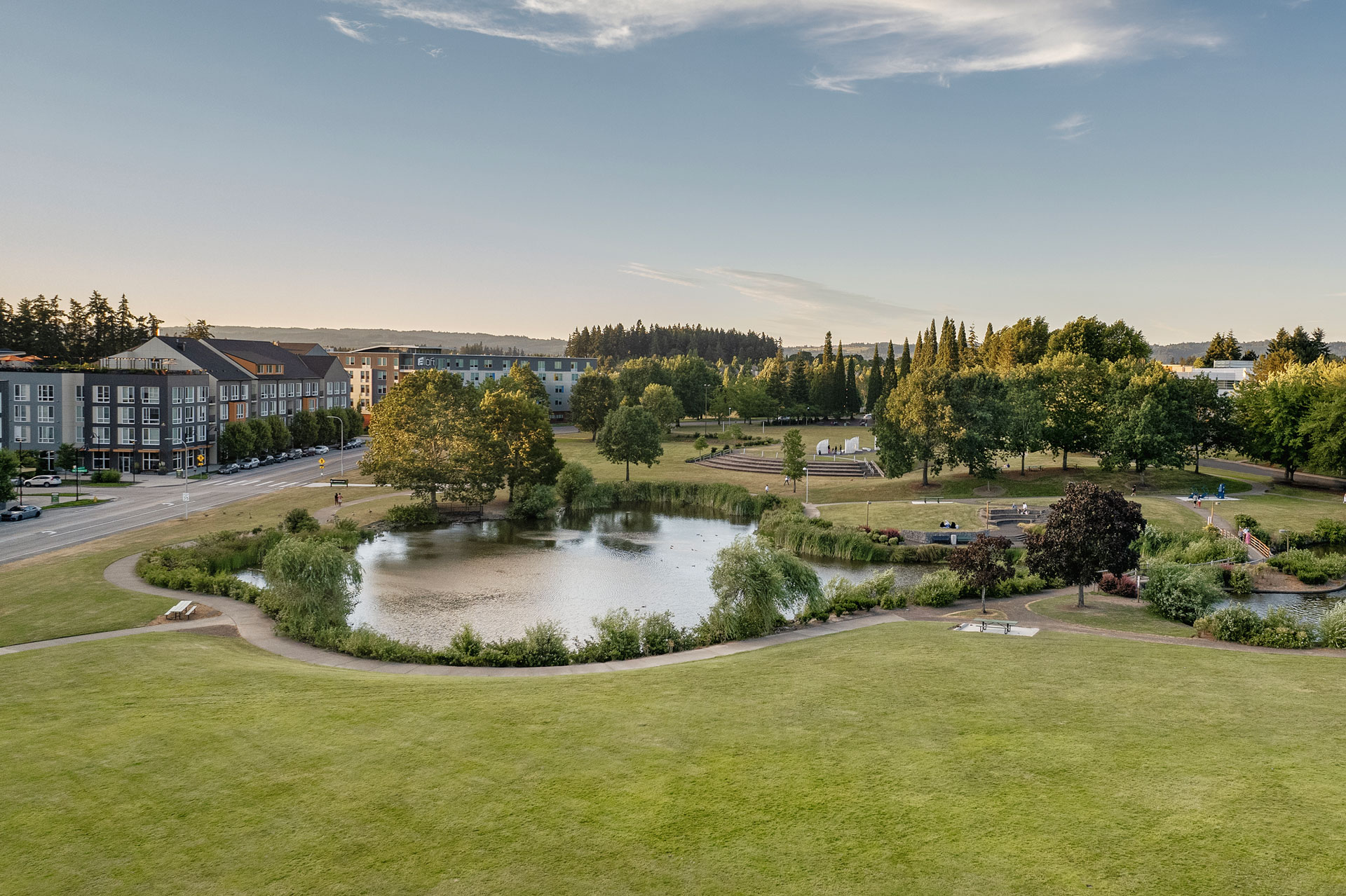 Wide view of a landscaped outdoor area with a pond