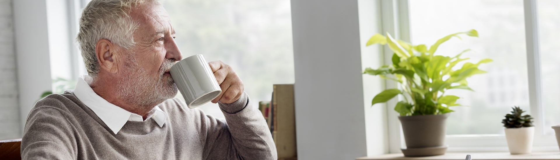 Senior man enjoying a cup of tea indoors