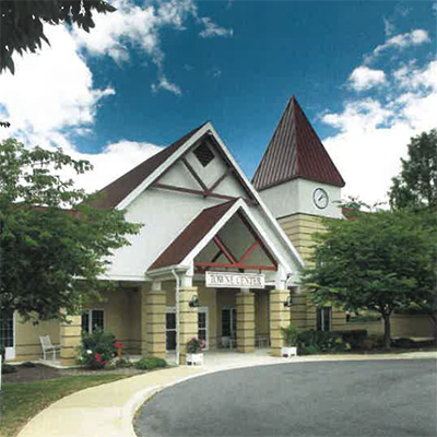 Exterior view of a senior living facility with a clock tower