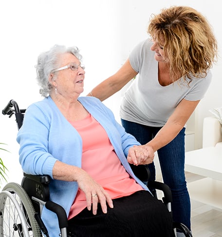 Staff helping a resident in a wheelchair
