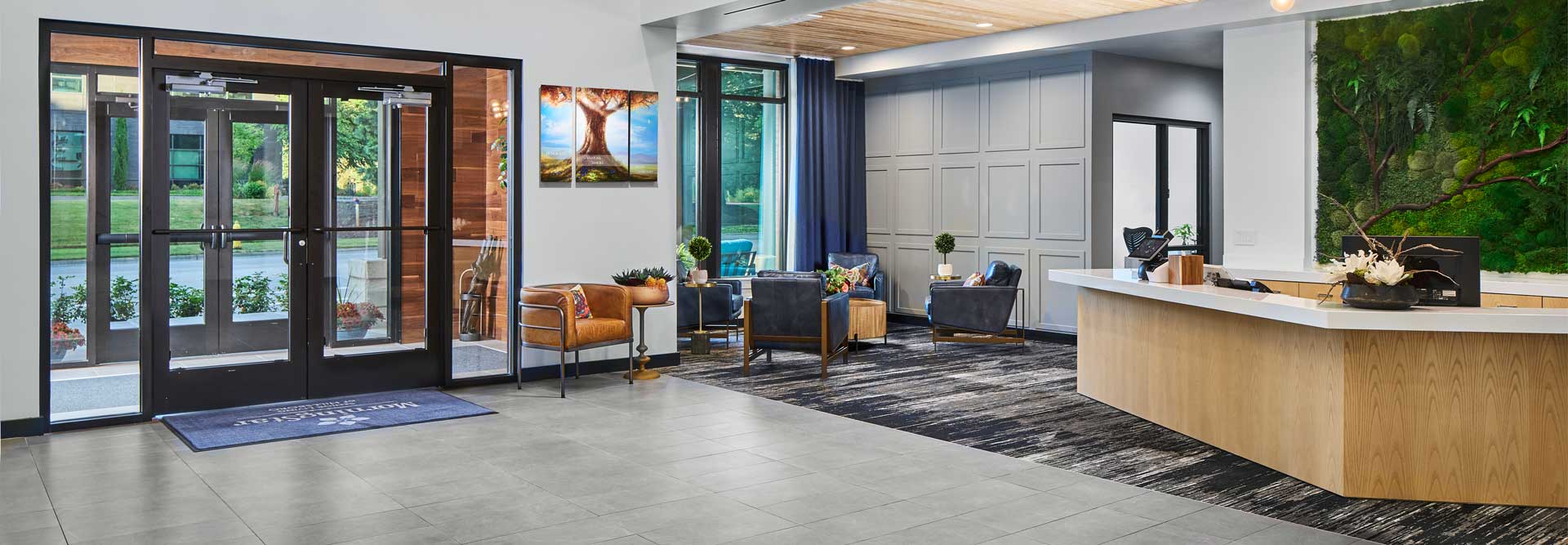 Bright and modern lobby area with seating and a reception desk