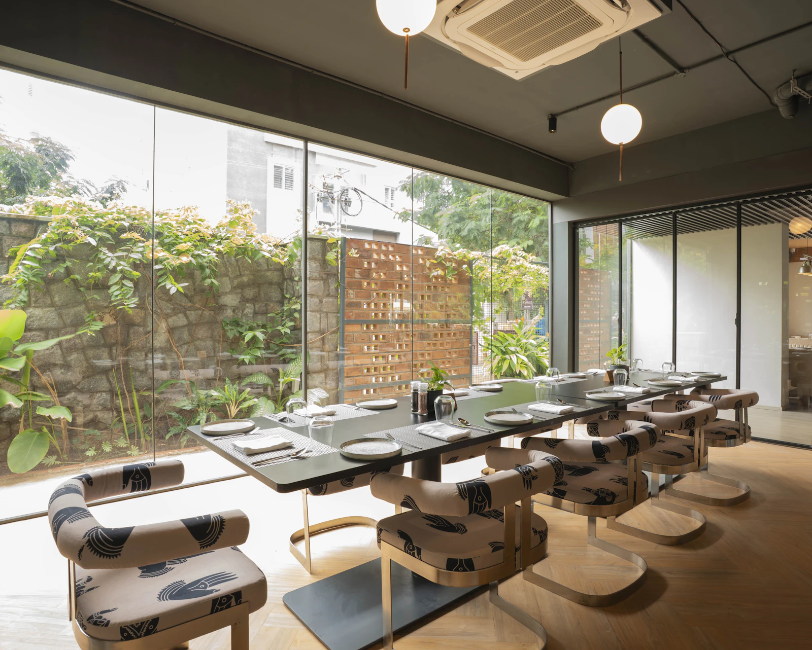 Bright dining area with glass windows and greenery