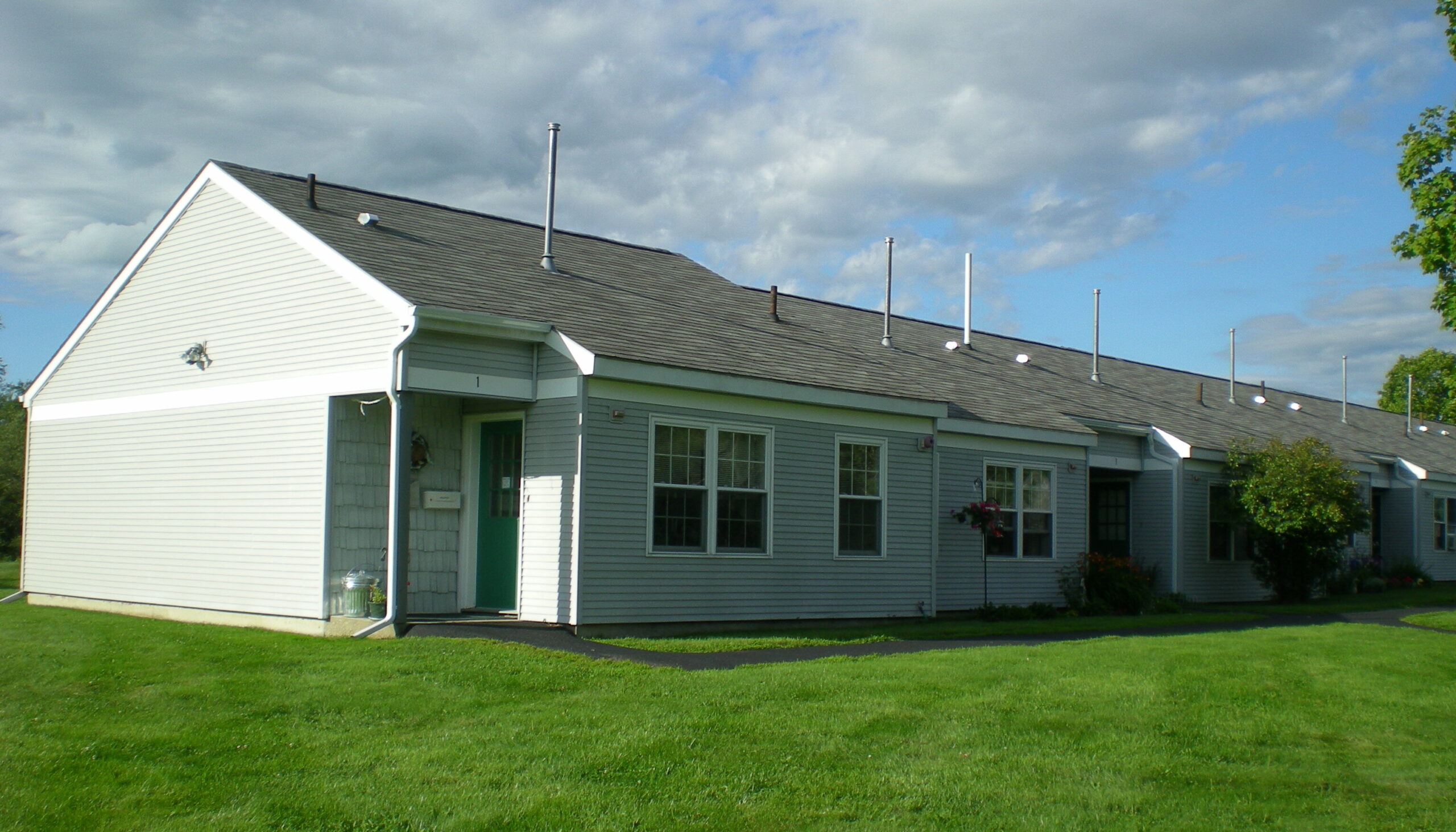 Exterior view of a residential building in a green setting