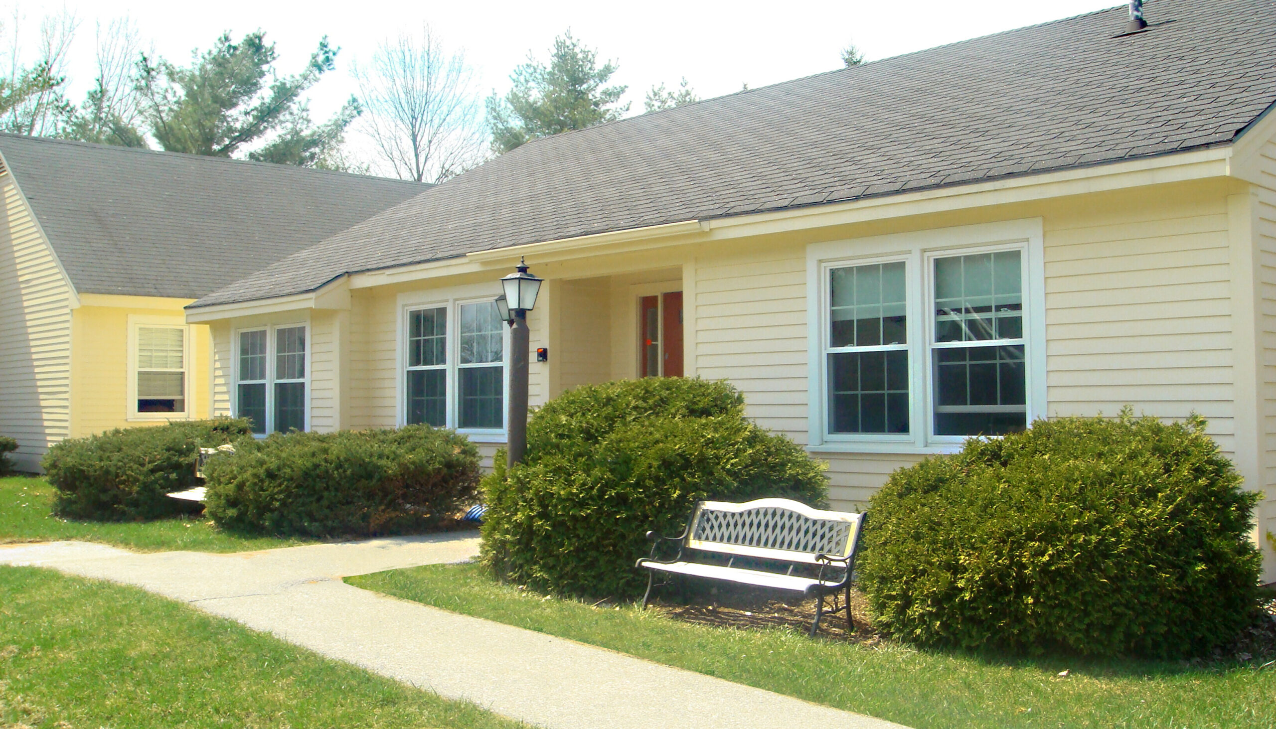 Exterior view of a senior living facility with landscaping