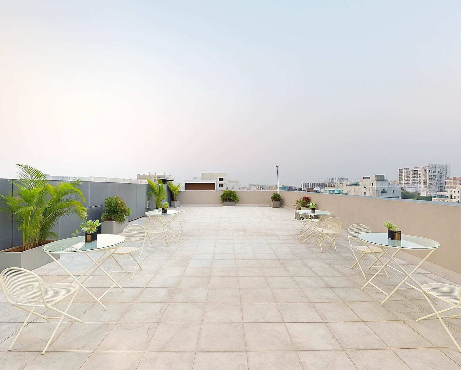Spacious rooftop terrace with tables and plants