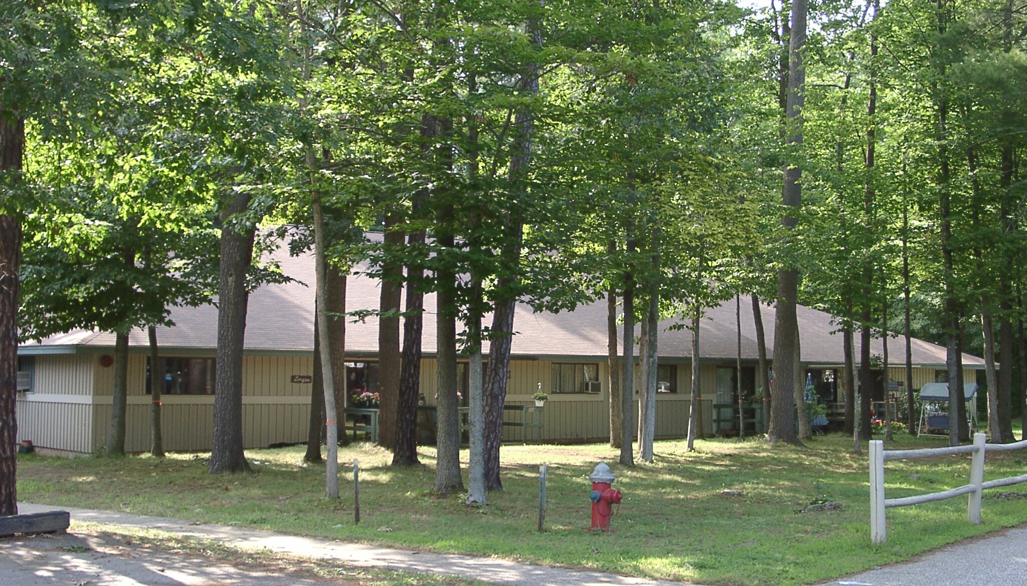 Exterior view of a senior living facility surrounded by trees