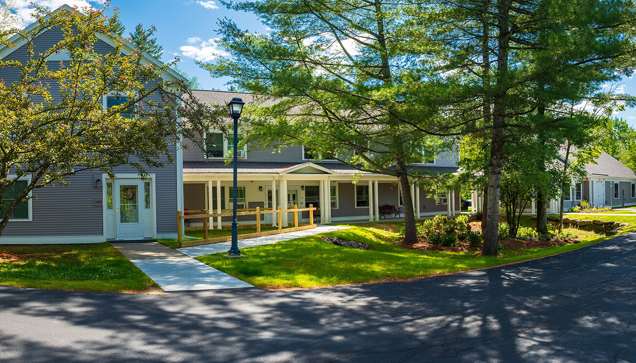 Front entrance of a senior living facility with landscaped gardens