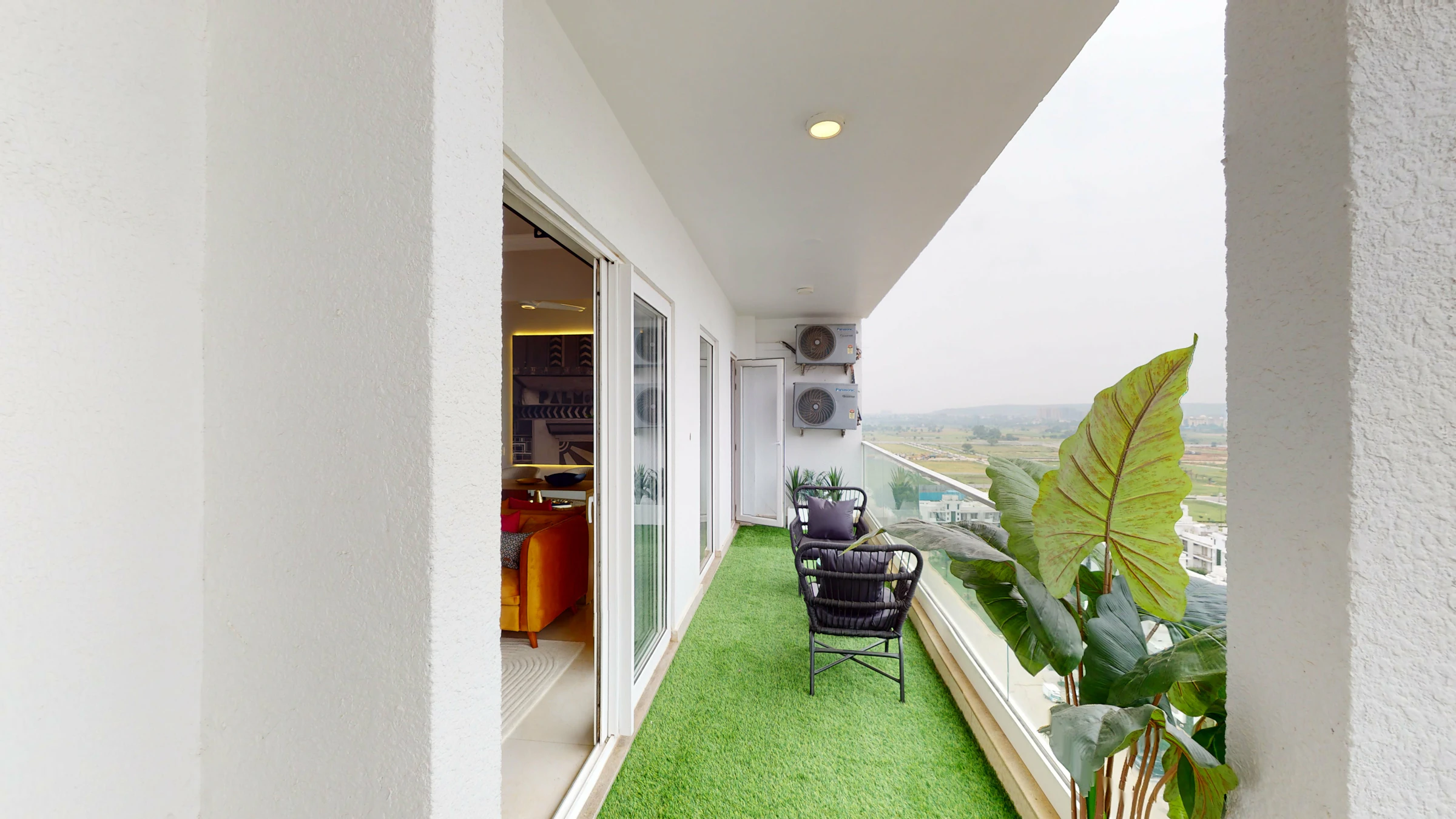 Balcony with plants and seating overlooking a scenic view