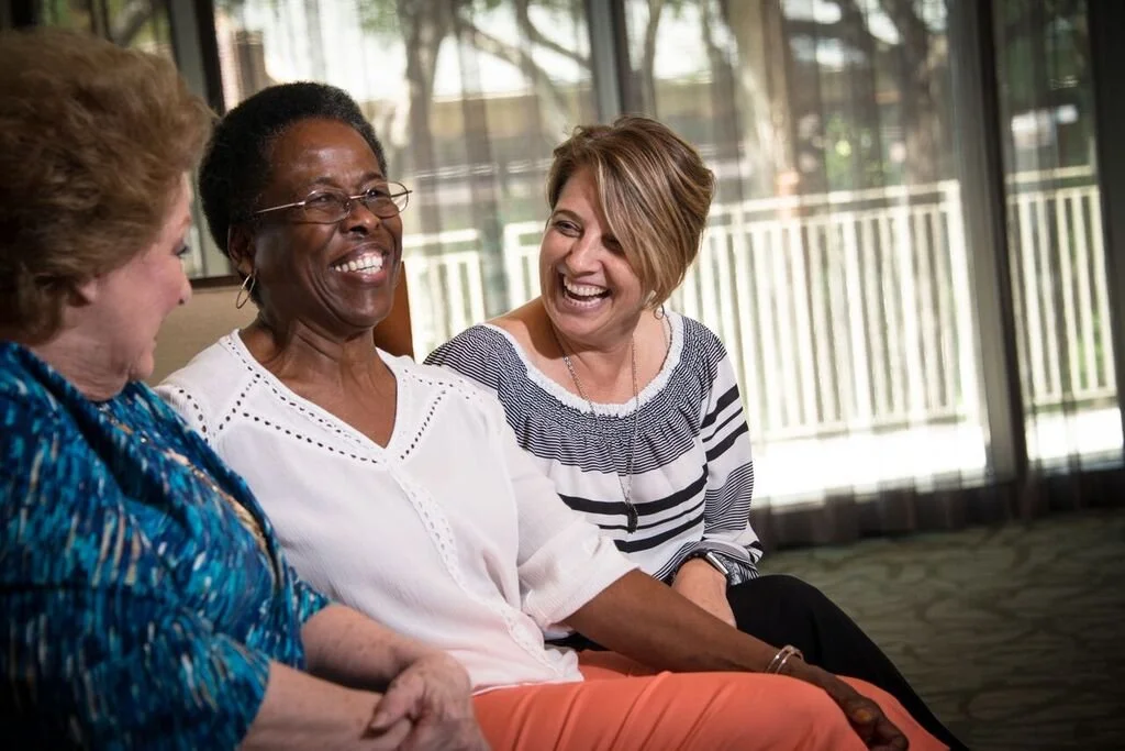 Residents and staff enjoying conversation in a common area