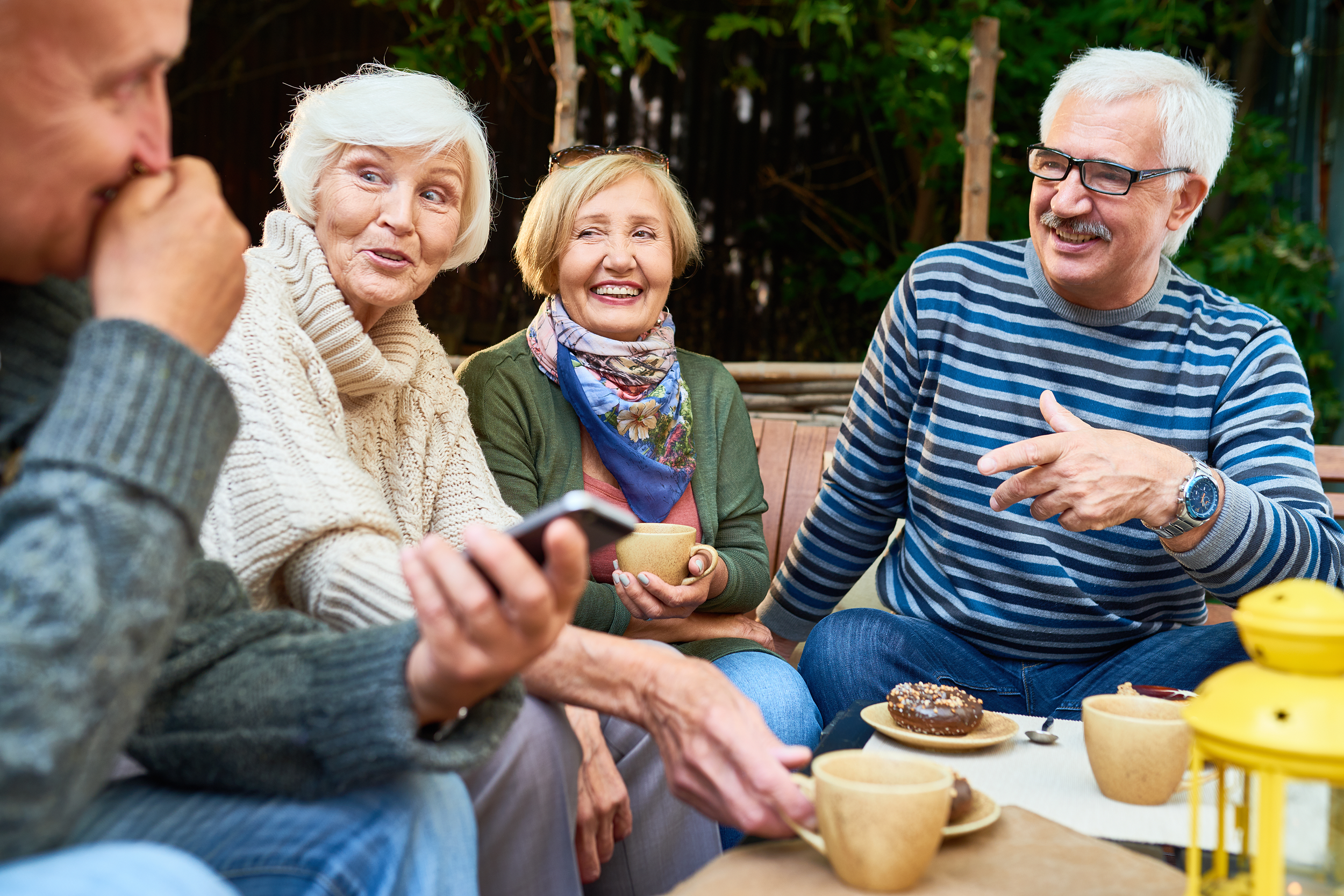 Residents enjoying coffee and conversation in a social setting
