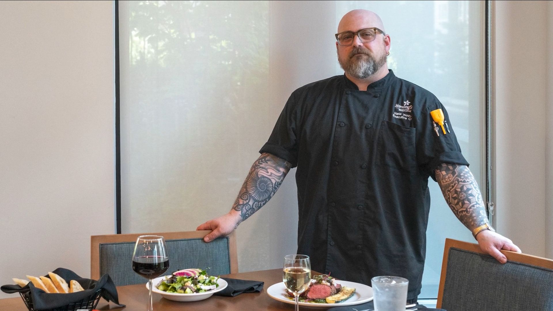 Chef presenting a gourmet meal in a dining area