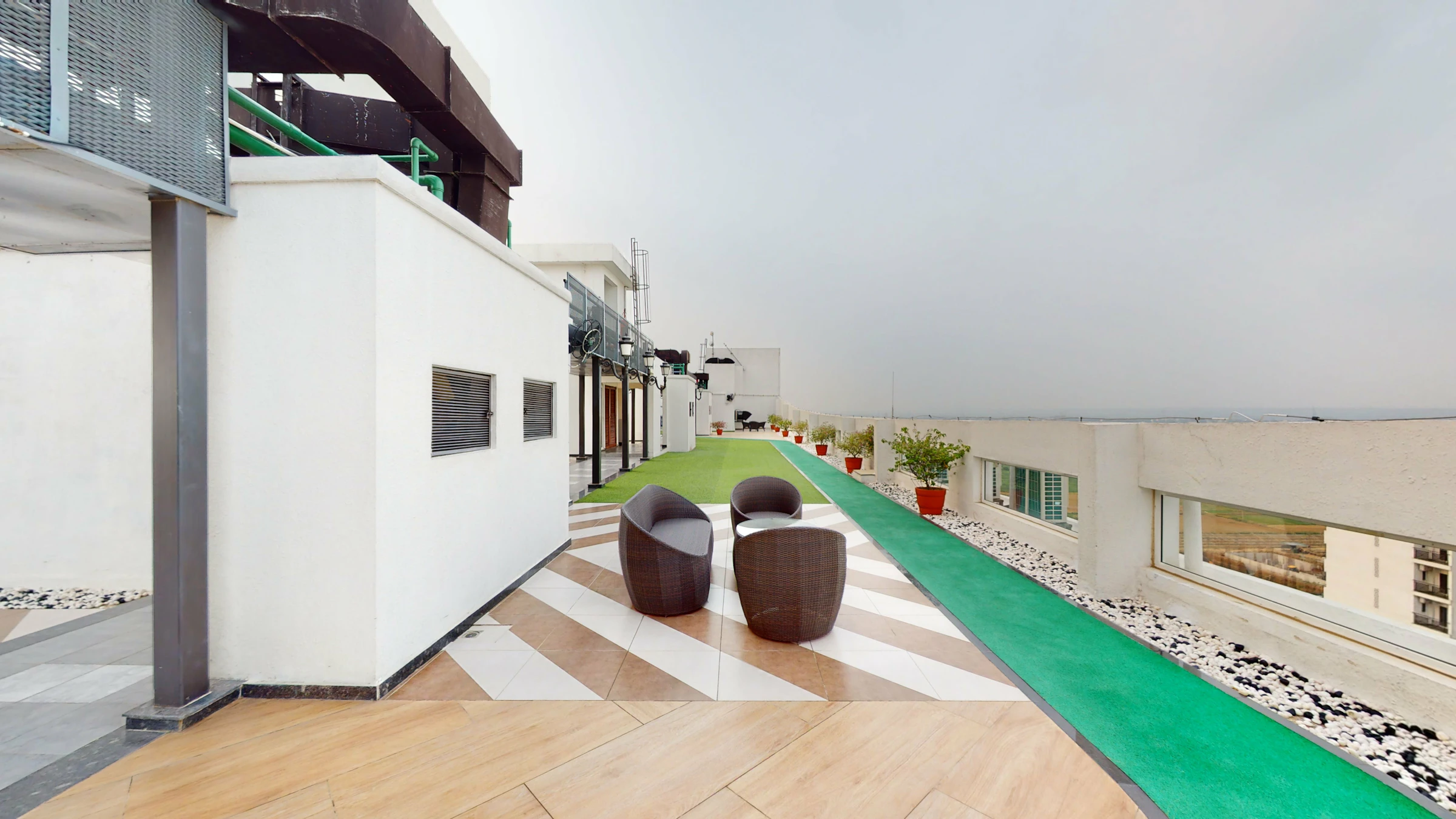 Outdoor seating area with greenery and walkway