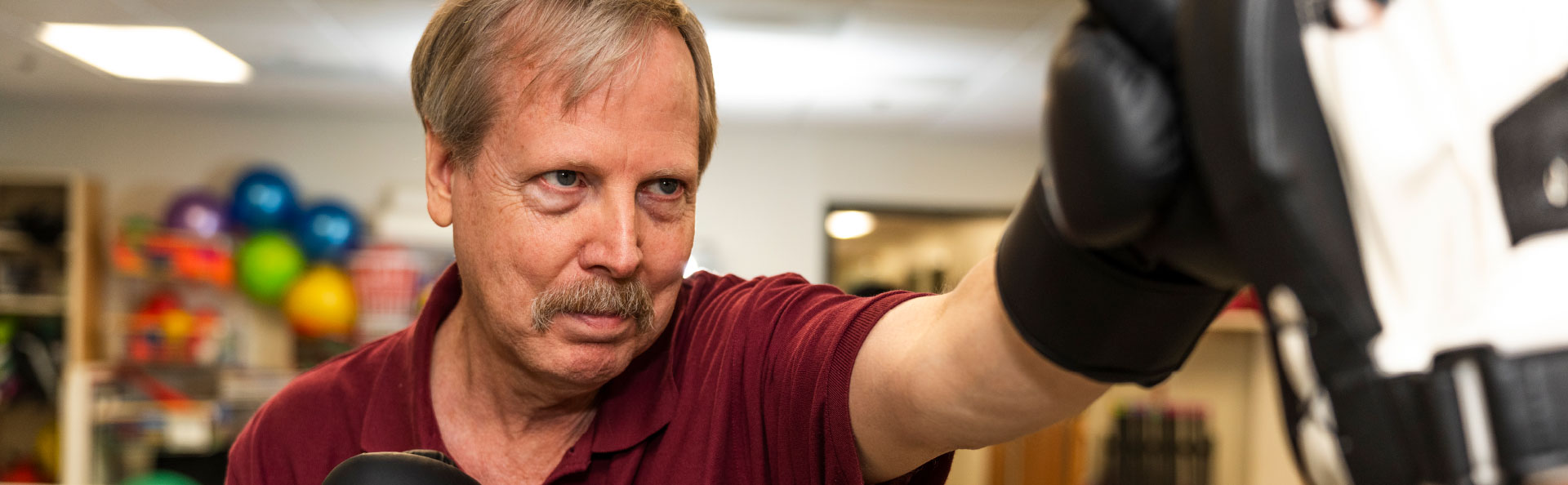 A resident participating in boxing therapy session