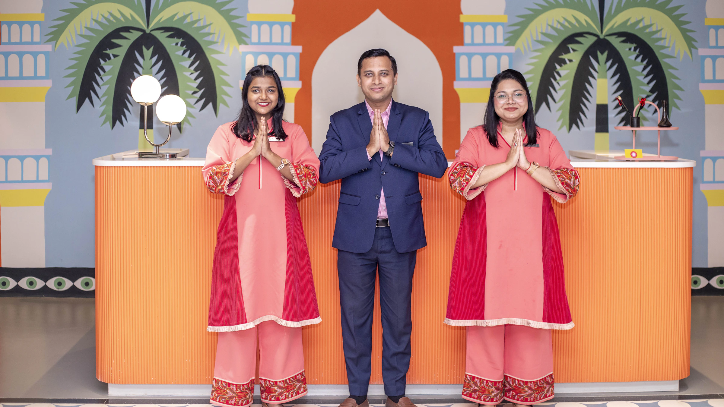 Staff members welcoming guests in a bright interior