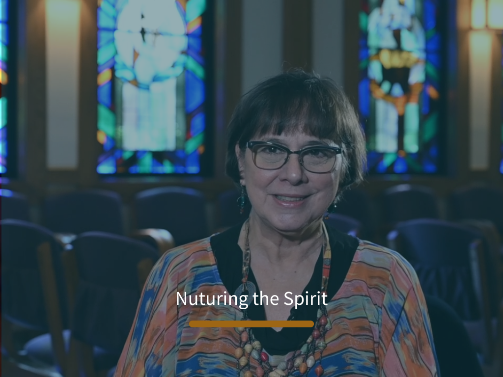 Resident speaking in a communal room with stained glass windows