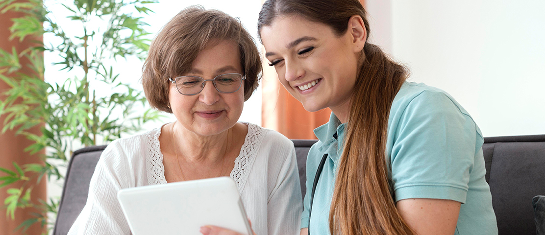Resident engaging with staff on a tablet