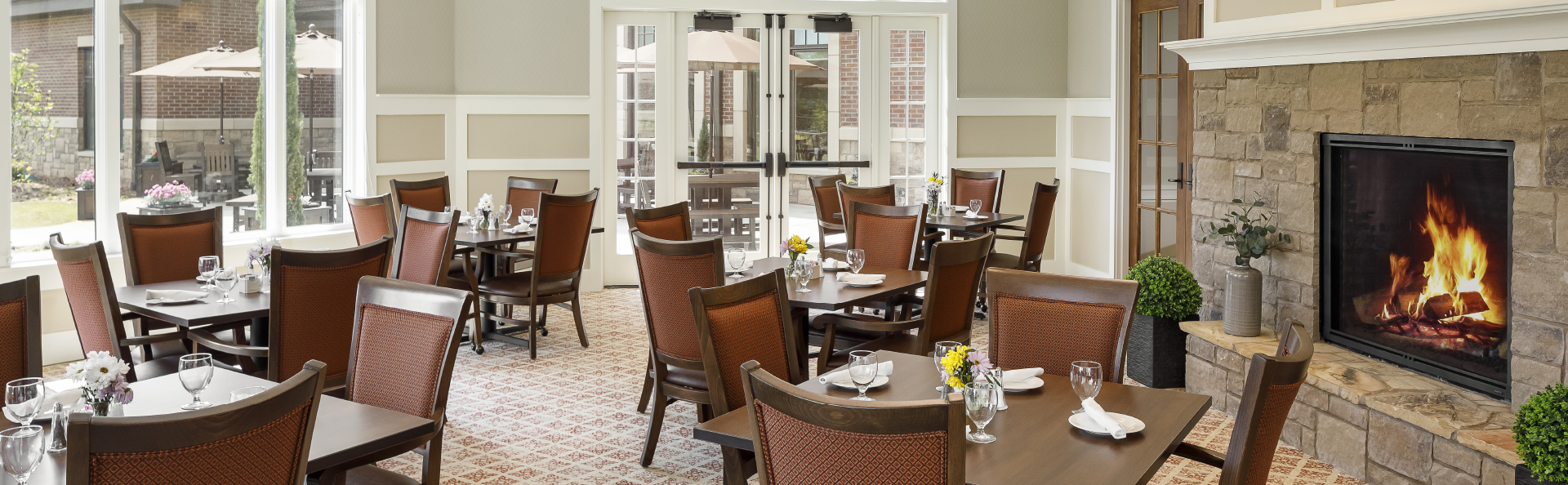 Bright dining room with tables and a fireplace