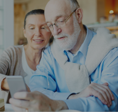 A resident and staff member interacting with a smartphone