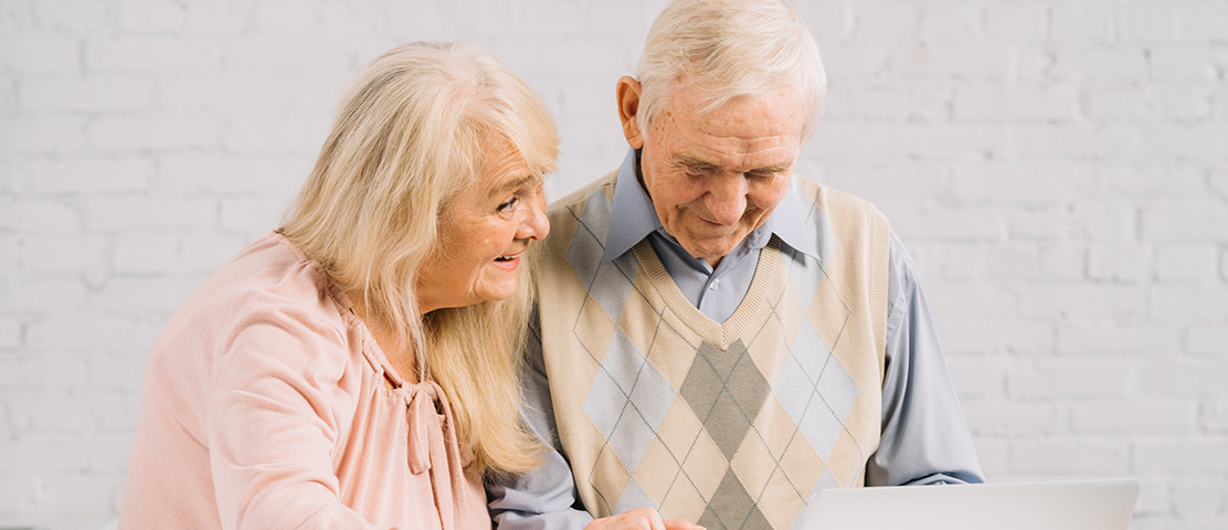 Elderly couple using a laptop together