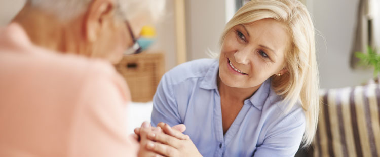 Caregiver interacting with a resident in a cozy room