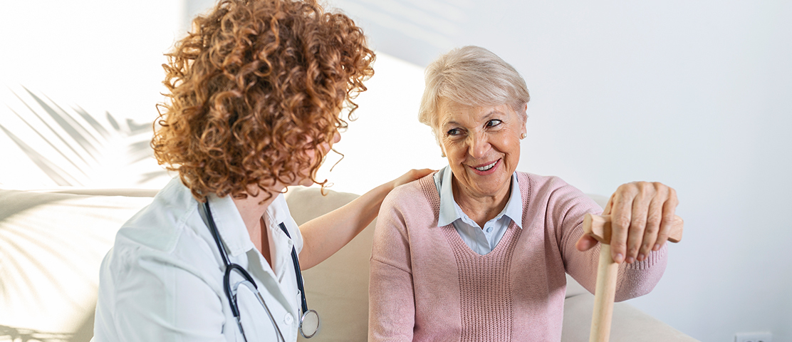 A staff member interacting with a smiling resident