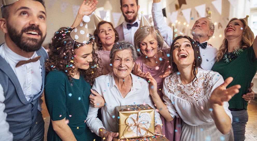 Residents and staff celebrating with confetti in a common area