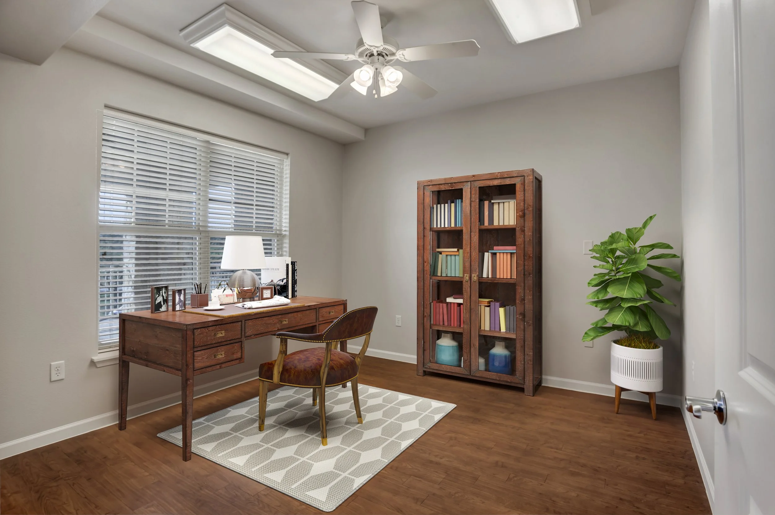 Brightly lit interior office with a desk and bookshelf