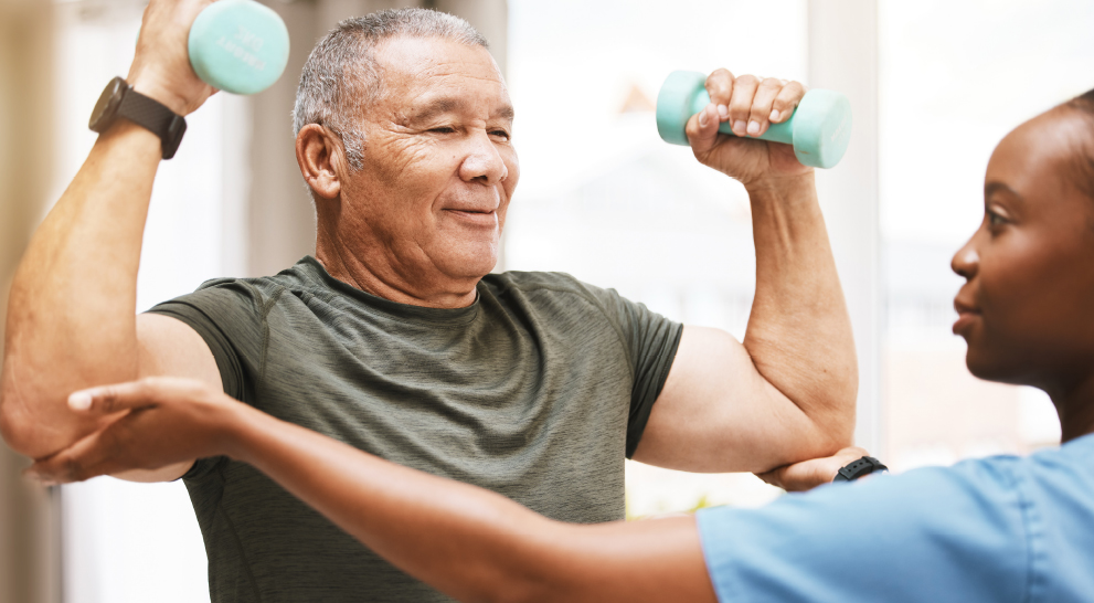 A senior man exercising with dumbbells in a bright room