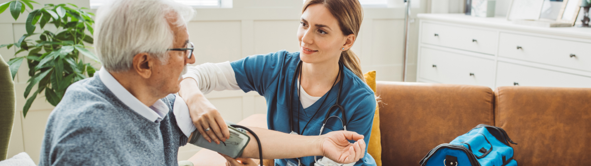 Nurse taking blood pressure of a senior resident