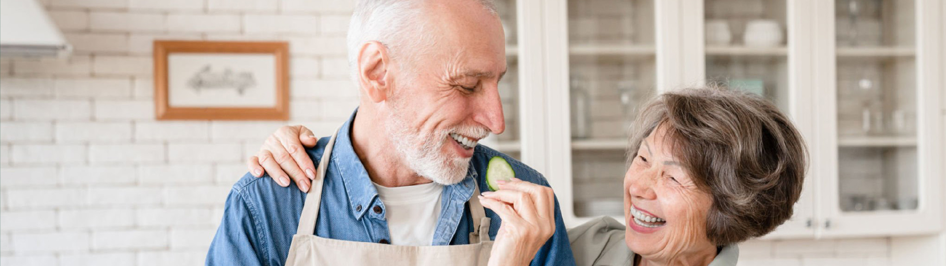 Two residents enjoying a lighthearted moment in a kitchen