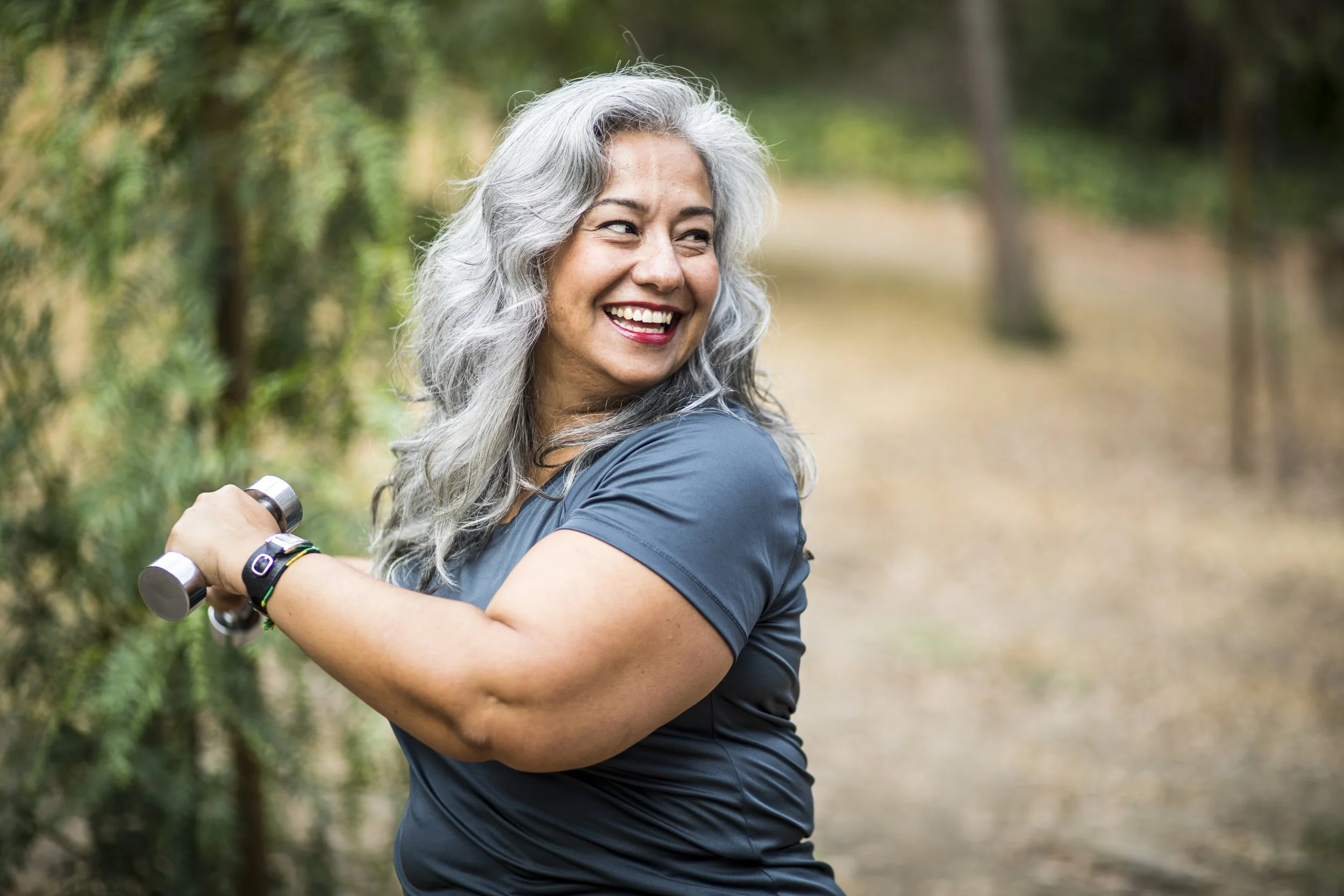Resident exercising with dumbbells in an outdoor space