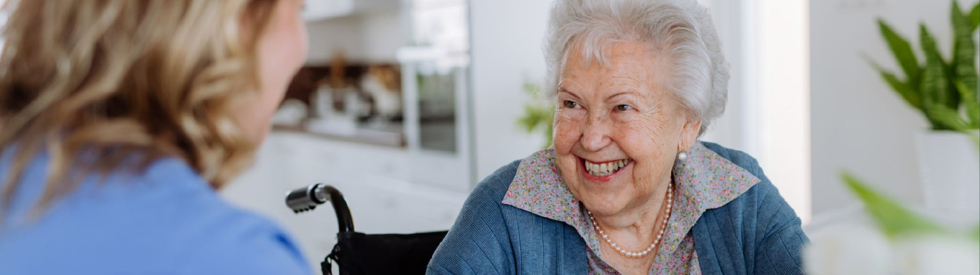 A resident smiling while interacting with staff