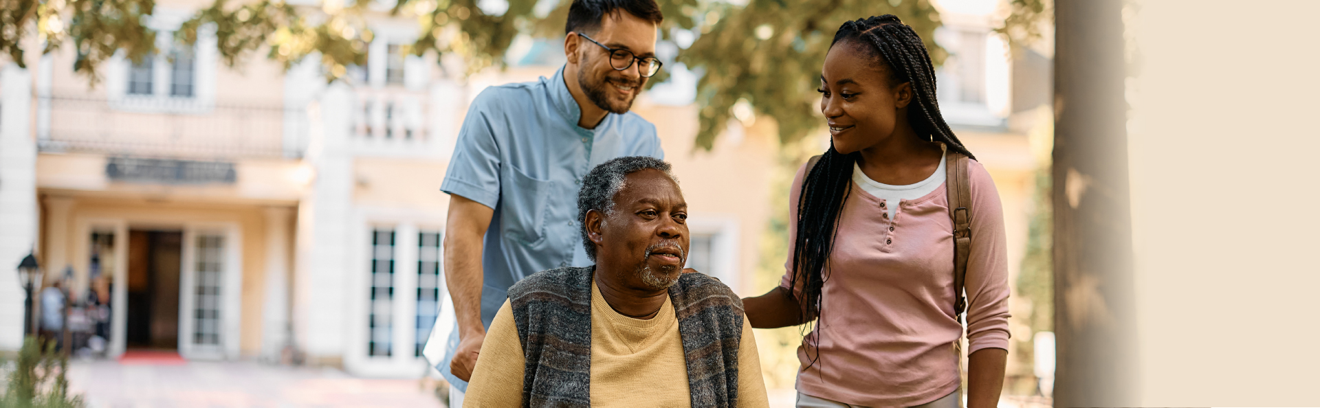 Residents enjoying time outdoors with staff assistance