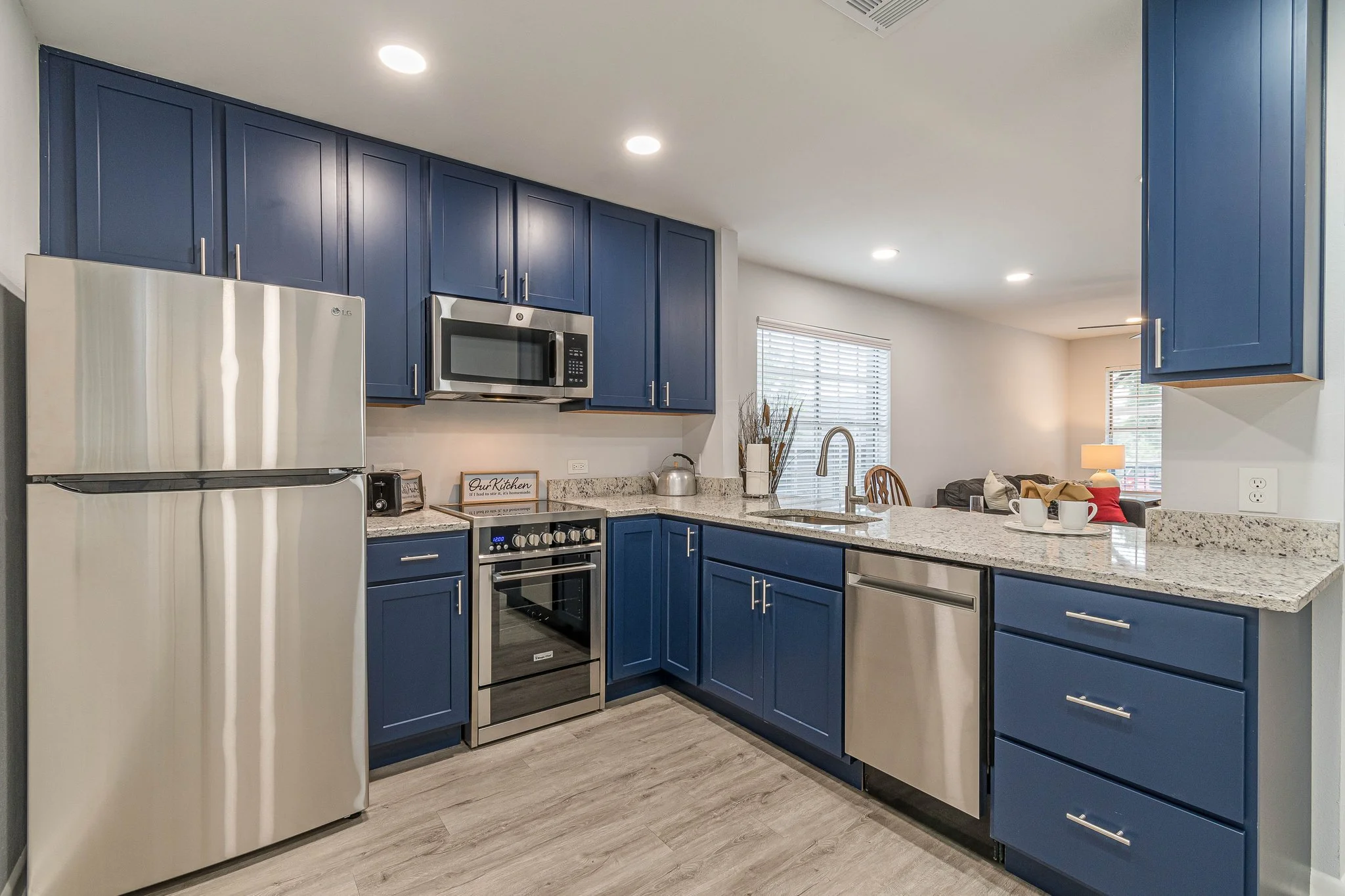 A modern kitchen with blue cabinets and appliances