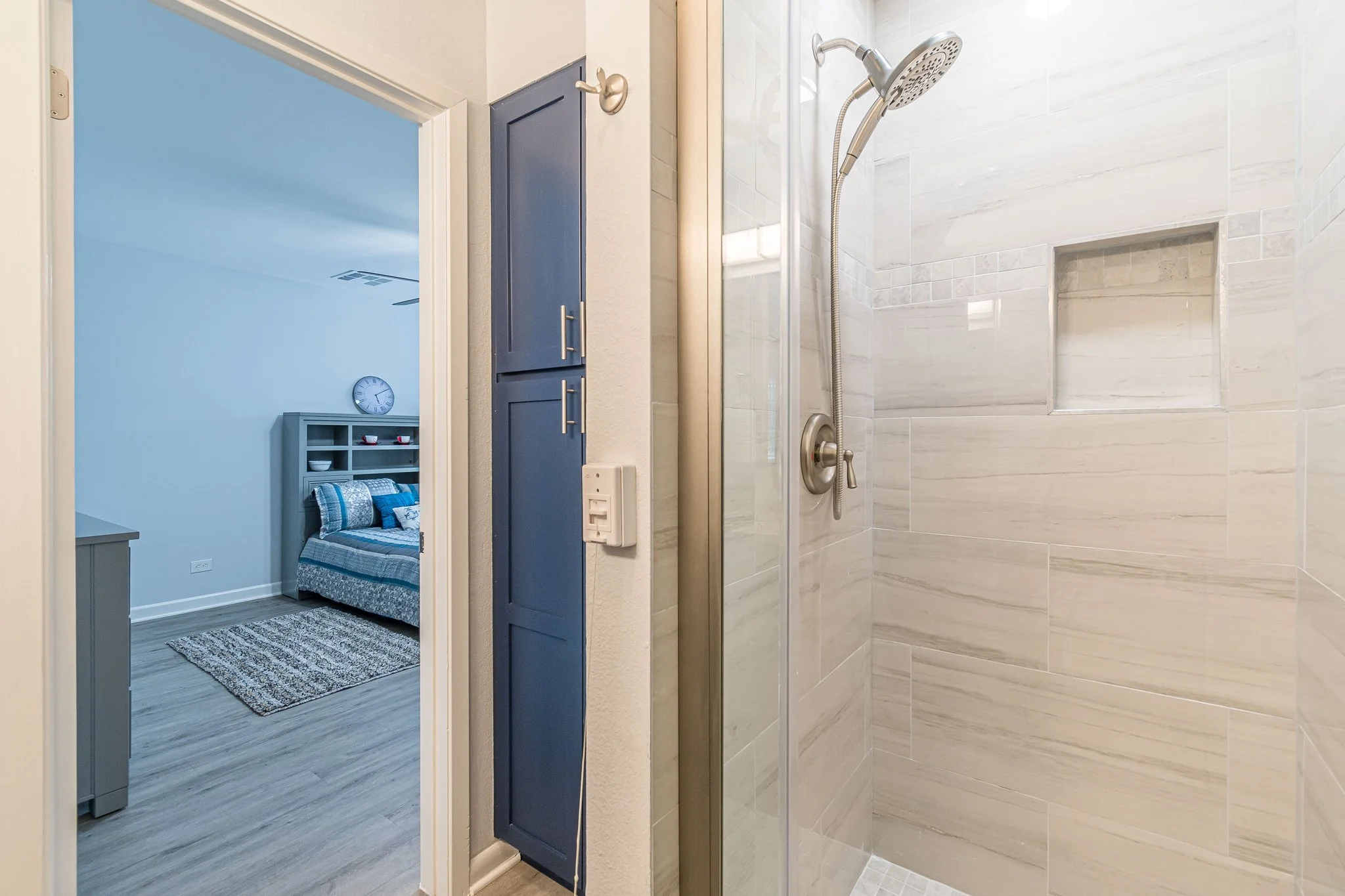 Modern shower in a resident room with blue accents