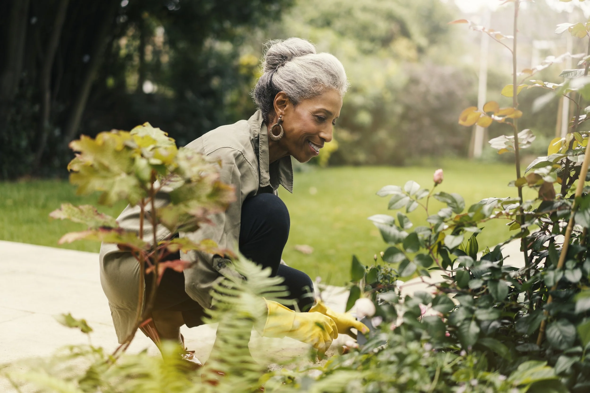 A woman gardening in a sunlit outdoor space