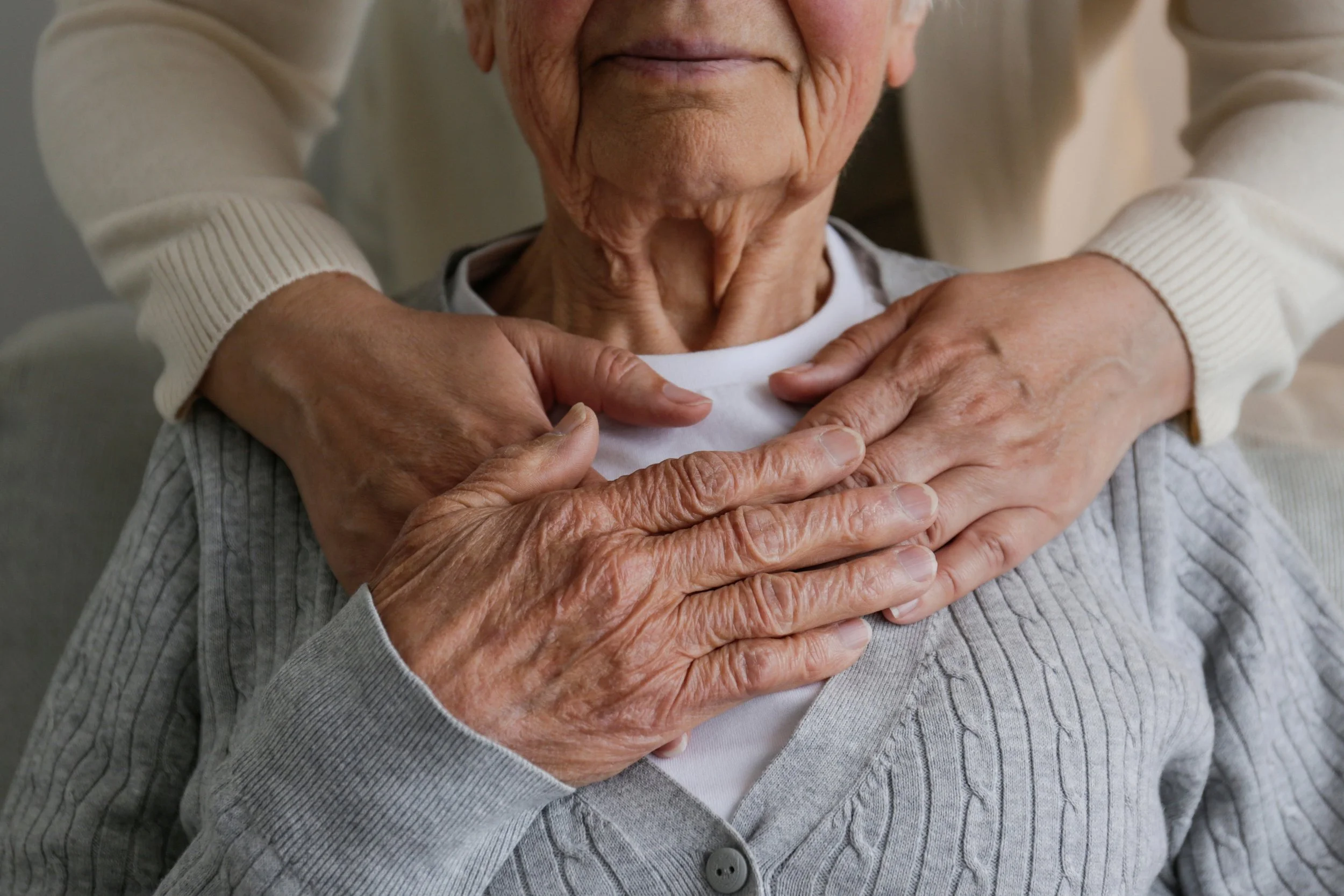 Close-up of elderly hands and caregiver's hands