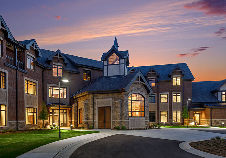 Exterior view of a senior living facility at sunset